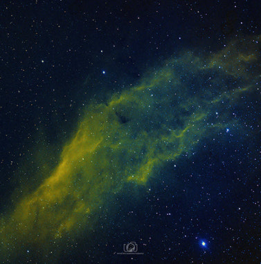 An enchanting image of the California Nebula, a celestial cloud of glowing hydrogen gas located in the constellation of Perseus. The nebula exhibits a distinctive shape resembling the outline of the state of California, with intricate patterns and filaments spanning across its expanse. This captivating cosmic marvel shines with warm hues of red and orange, showcasing the ethereal beauty and vastness of the universe.